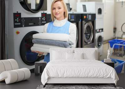 portrait of a woman laundry worker at the dry cleaners Wall mural