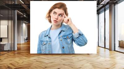 Portrait of young attractive beautiful thoughtful happy redhead female student thinking looking at copyspace, isolated on white background. Woman in blue jeans Wall mural