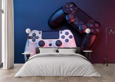 Two video game controllers, joysticks for game console isolated on black background. Gamer controlling devices close-up Wall mural