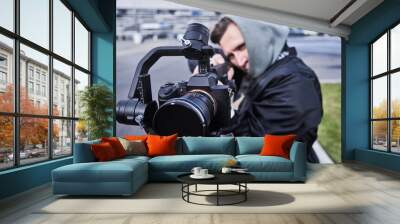 Video camera operator working with professional equipment close up Wall mural