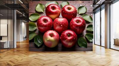 vibrant red apples with glistening water droplets arranged in a circular pattern on a rustic wooden surface soft natural lighting enhances the apples glossy skin and fresh green leaves Wall mural