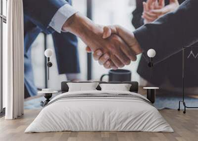 Business people shake hand to confirm the agreement in the business of mutual investment and agree on a unified work contract. Wall mural