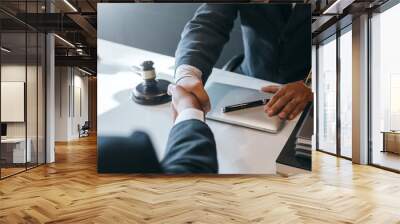 Businessman shaking hands to seal a deal with his partner lawyers or attorneys discussing a contract agreement. Wall mural