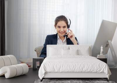 Call center worker. Smiling operator woman with headset and computer at office. Wall mural