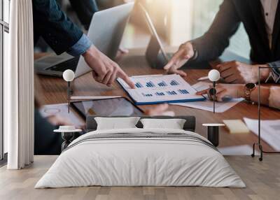 Close up view of business people investment advisors pointing at graph and analyzing financial report in meeting. Wall mural