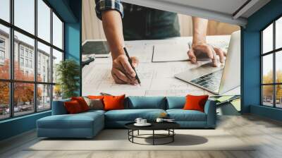 Engineer man working in the office, Drawing the construction project. Wall mural