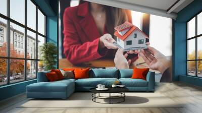 real estate agent to buy house and land are delivering house to customer after agreeing to make a ho Wall mural