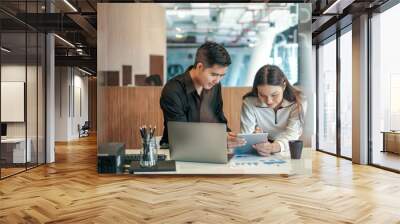 Young asian business people working together on a modern office project. Wall mural