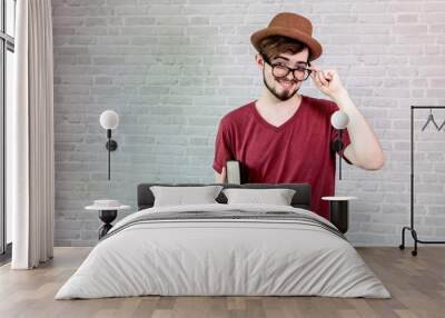 Young man wear a red shirt holding a bible. Wall mural