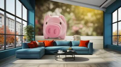 Piggy bank on wood table with coin Wall mural