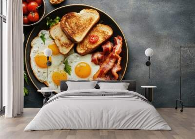 A flat lay of a hearty breakfast with eggs, bacon, and toast, with room for copy Wall mural