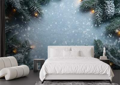 Frosted evergreen branches with twinkling lights on a snowy surface. Room for holiday text Wall mural