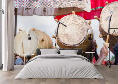 selective focus of musical instruments- group of africans carrying drums outdoor- traditional musica Wall mural