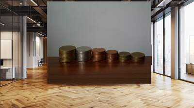 stack of coins on wooden table Wall mural