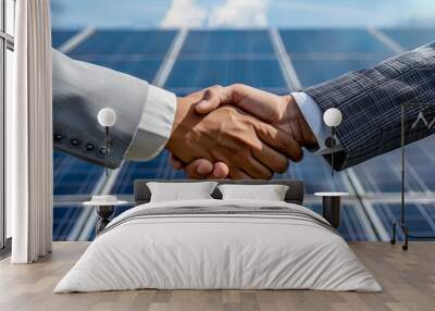 Two people having a shaking hands against solar panel after the conclusion of the agreement in the renewable energy  Wall mural