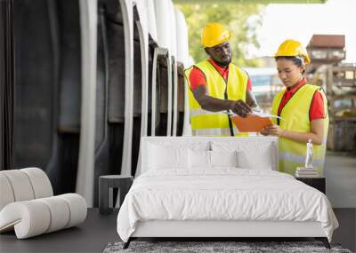 African American male and female worker in safety vest and helmet working with clipboard at automotive spare parts warehouse. people, car service, repair and maintenance concept Wall mural