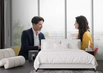 Business man and business woman discussing strategy business planning together on office desk in office. Two man and woman partnership meeting and working with document paper in office Wall mural