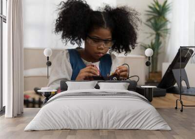 Child girl student learning and checking electric current on toy robotics at home. Technology and scientist at school concept Wall mural