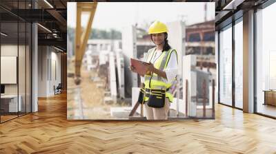 Foreman builder woman at construction site. Asian foreman construction woman working at construction site Wall mural