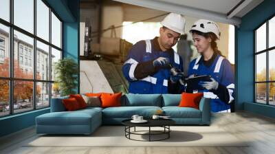 Group of engineer working together in industry factory, wearing safety uniform, safety helmet Wall mural