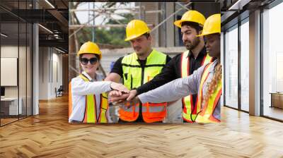 Group of male and female engineer construction working and join hands together at construction site. Foreman construction working at construction site Wall mural