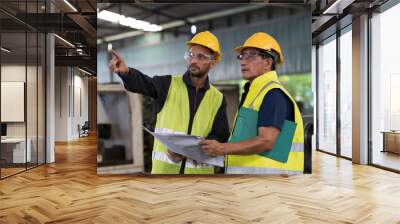 Group of male engineer worker discuss and working together in industry factory. Male engineer repairing or maintenance CNC machine in factory Wall mural