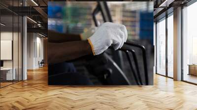 Hands of  male warehouse worker driving and operating on forklift truck for transfer products or parcel goods in the industrial storage warehouse Wall mural