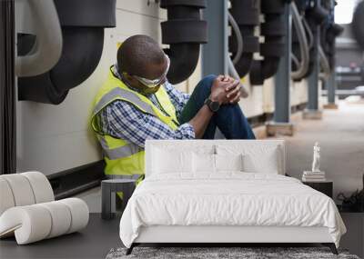 Male worker accident with broken leg at sewer pipes area at construction site. Health insurance concept Wall mural