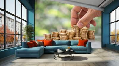 Money Financial Business Growth concept Man hand put money gold coins to stack Wall mural