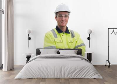 Portrait of male engineer wear uniform and helmet standing witch crossed arms on white background Wall mural