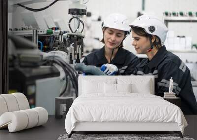 Two female engineers control autonomous mobile robot or AMR in the manufacturing automation and robotics academy room. Group of female engineers training or maintenance AI robot Wall mural