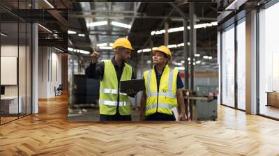 Two male engineer worker discuss and working together in industry factory. Male engineer repairing or maintenance CNC machine in factory Wall mural