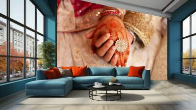 A couple holding in hand at wedding day. Indian couple holding hand on their wedding Wall mural