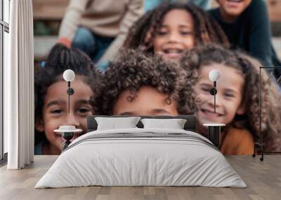 A group of children with curly hair are smiling and posing for a picture, scene is happy and joyful, as the children are enjoying each other company and having a good time Wall mural