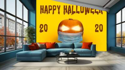 Spooky pumpkin wearing a face mask for COVID, background for Halloween 2020, COVID-19 Wall mural