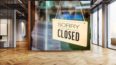 Sorry we are closed sign board hanging on door of cafe Wall mural