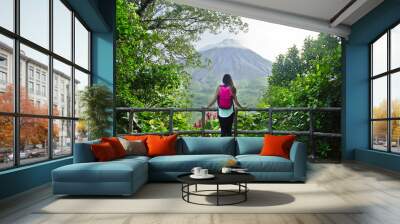 Female hiker looking out at the Arenal volcano in Costa Rica Wall mural