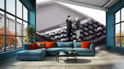 two miniature businessmen shaking hands Wall mural