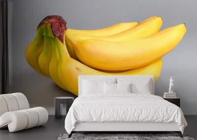 Cluster of ripe bananas on a gray background close-up Wall mural