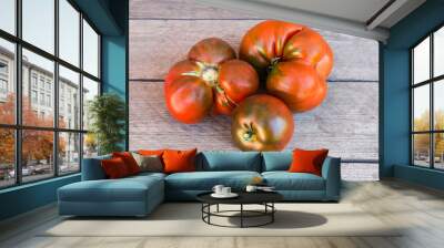 Different tomatoes kumato on the old rough wooden surface Wall mural