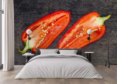 Two halves of red bell pepper on the dark surface Wall mural