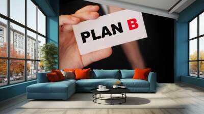 Plan B words on card in hand of businessman wearing suit and tie. Alternative business concept Wall mural