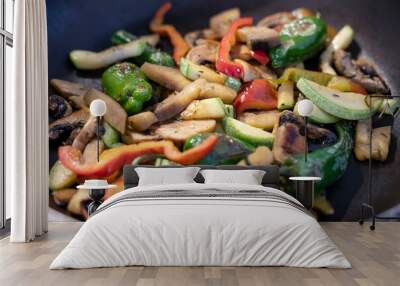 Colorful mix of sauteed vegetables in a pan: sliced mushrooms, zucchini, red, yellow and green bell peppers, lightly cooked veggies used in a healthy stir-fry or as a perfect side dish or main course Wall mural