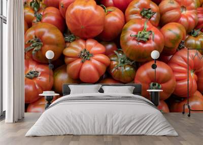 Oversized heirloom tomatoes in a pile at the Farmers' Market, beautiful fresh vegetable with an exceptional taste and culinary versatility preferred for their crisp texture, rich flavour and juiciness Wall mural