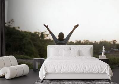 Praising the lord. A woman with her arms raised to the sky in thankfulness and prayer. Themes such as Intercede, Benediction, Supplicate, Atonement, Confession, Comfort, Shelter, Solace, Shield Wall mural