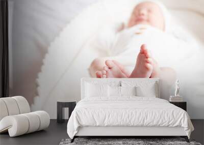 Tiny baby feet of the newborn baby in her mother's hand. Infant feet in the hand of a parent.  Wall mural