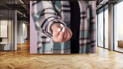 Young woman asks for money by hand. Wall mural