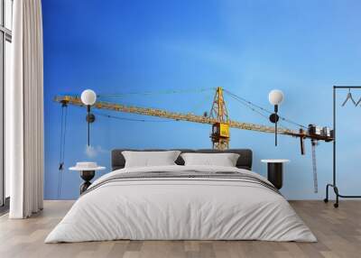 Crane ,on construction site blue sky background Wall mural