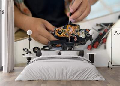 engineer fixing a  film camera with tools. Wall mural