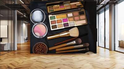 Set of make up brushes  with cosmetics on black background Wall mural